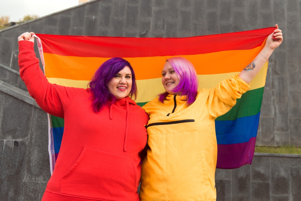 Two happy people celebrating holding a flag